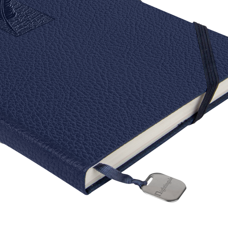 Blue textured notebook with a strap and visible brand name on a white background