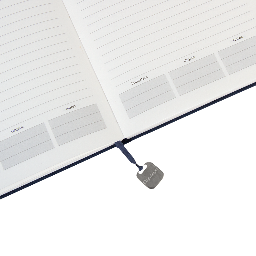 Open notebook with labeled sections and a visible brand tag on a white background