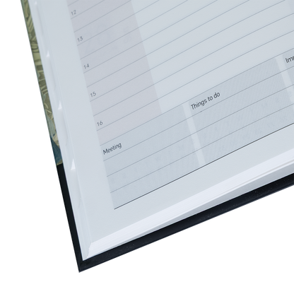 Close-up of a planner with grid layout and text boxes on a white background