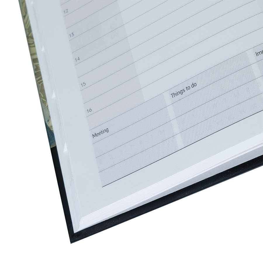 Close-up of a planner with grid layout and text boxes on a white background