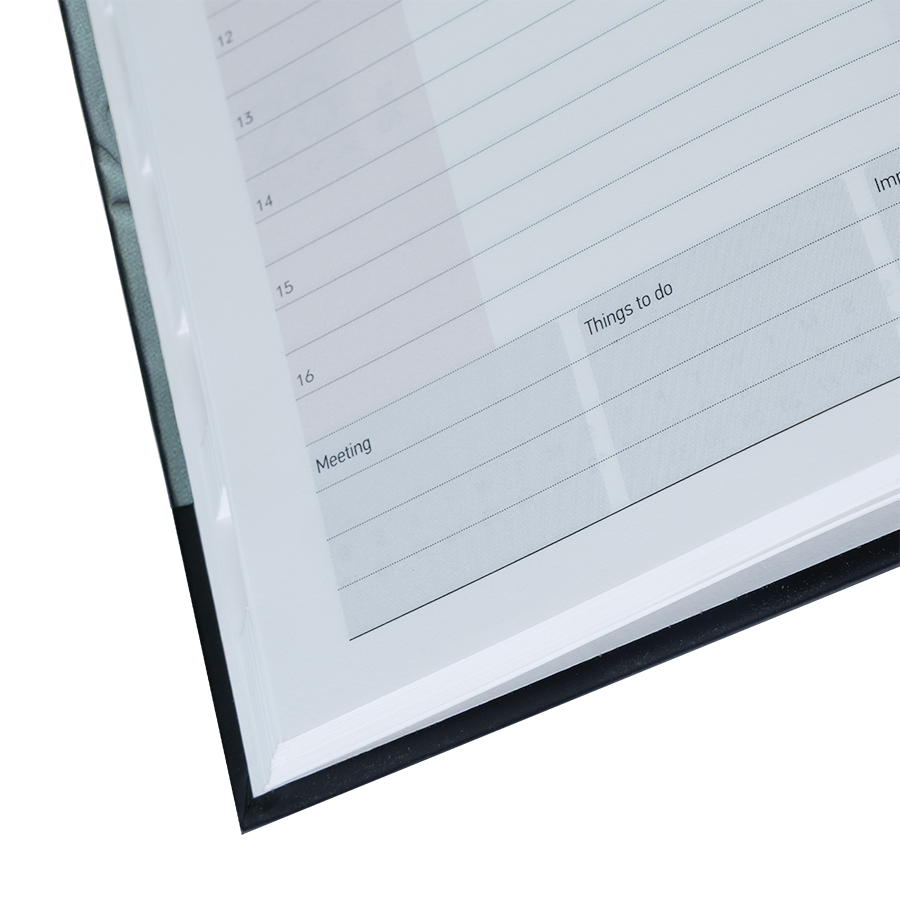 Close-up of a planner page with text and grid layout on a white background