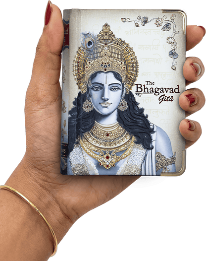 Hand holding a book titled 'The Bhagavad Gita' with an illustration of a deity on the cover.