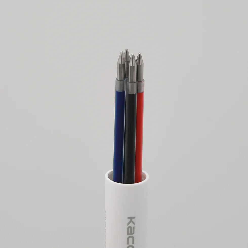 Three drill bits in a white holder on a gray background