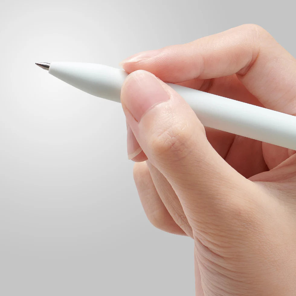 Hand holding a white pen against a light gray background