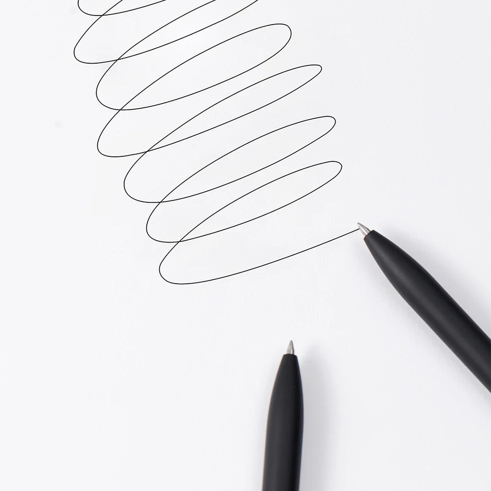 Two black pens drawing curved lines on a white background