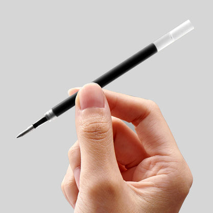 Hand holding a black and clear pen against a gray background