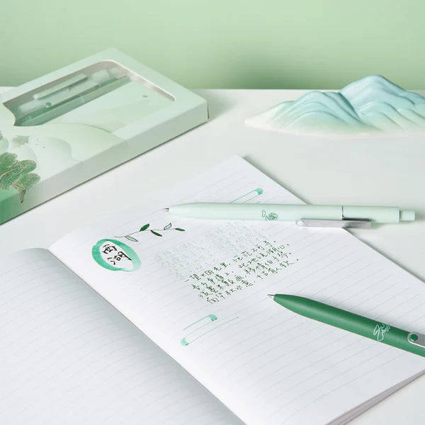 Green pen and notebook on a light green background