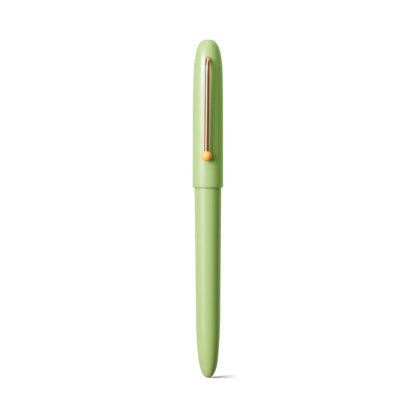 Green pen with a rose gold clip on a white background