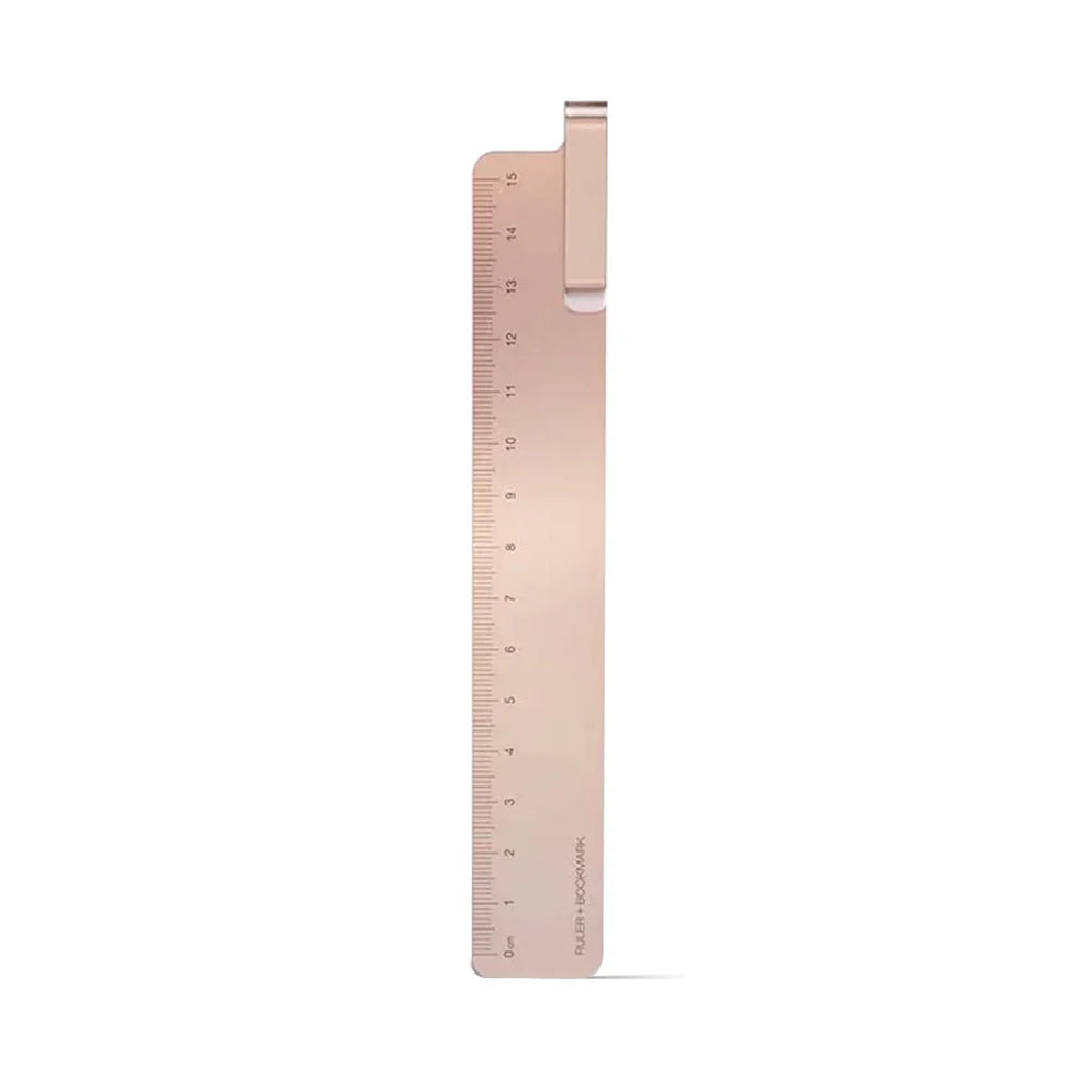 Rose gold ruler on a white background