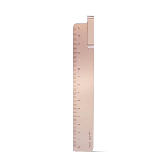 Rose gold ruler on a white background