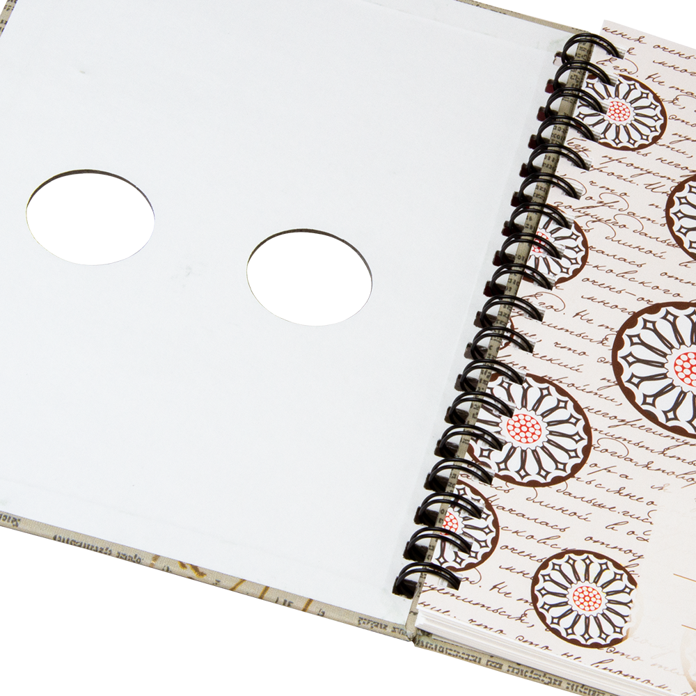 Spiral-bound notebook with floral design on a white background