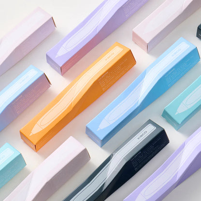 Colorful boxes with a pen inside on a light background