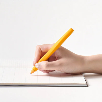 Hand holding a yellow pen over a notebook on a white background