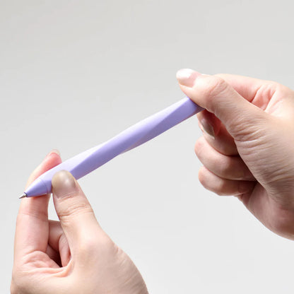 Hand holding a purple pen against a light gray background