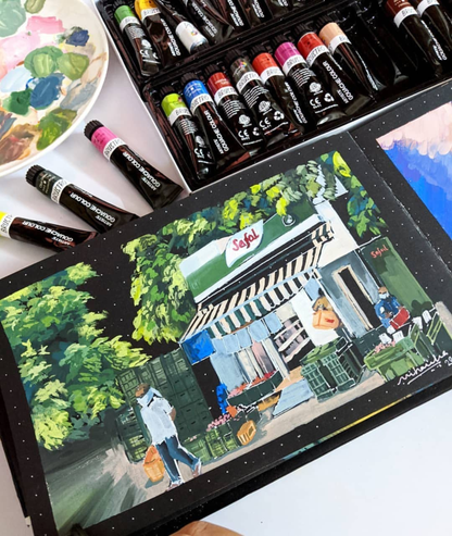 Art supplies including markers and a completed painting of a street scene with people and a store.