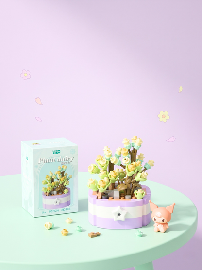 Small potted plant with a matching box on a light green table against a light purple background