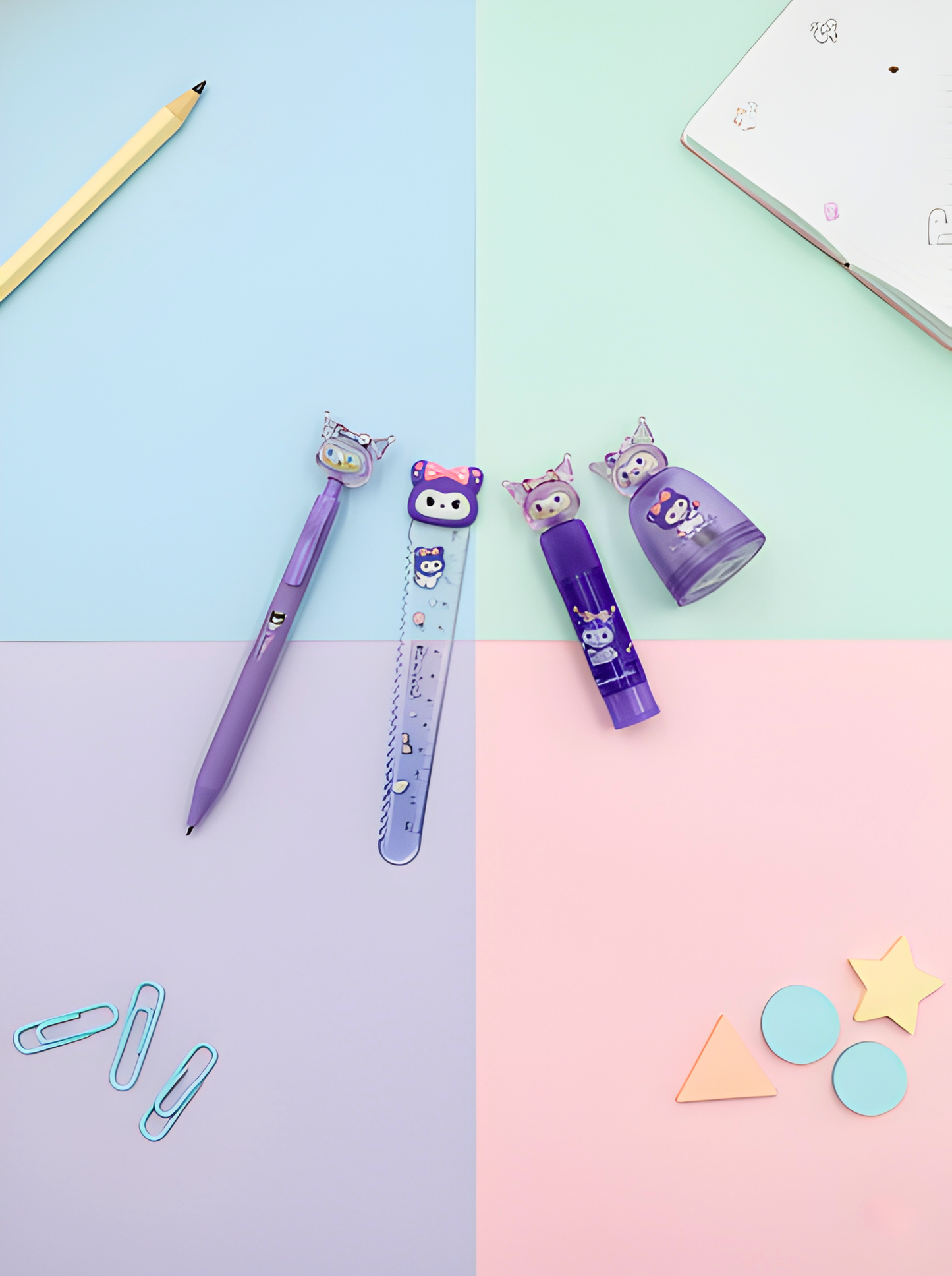 Stationery items including a pen, ruler, and markers on a pastel background