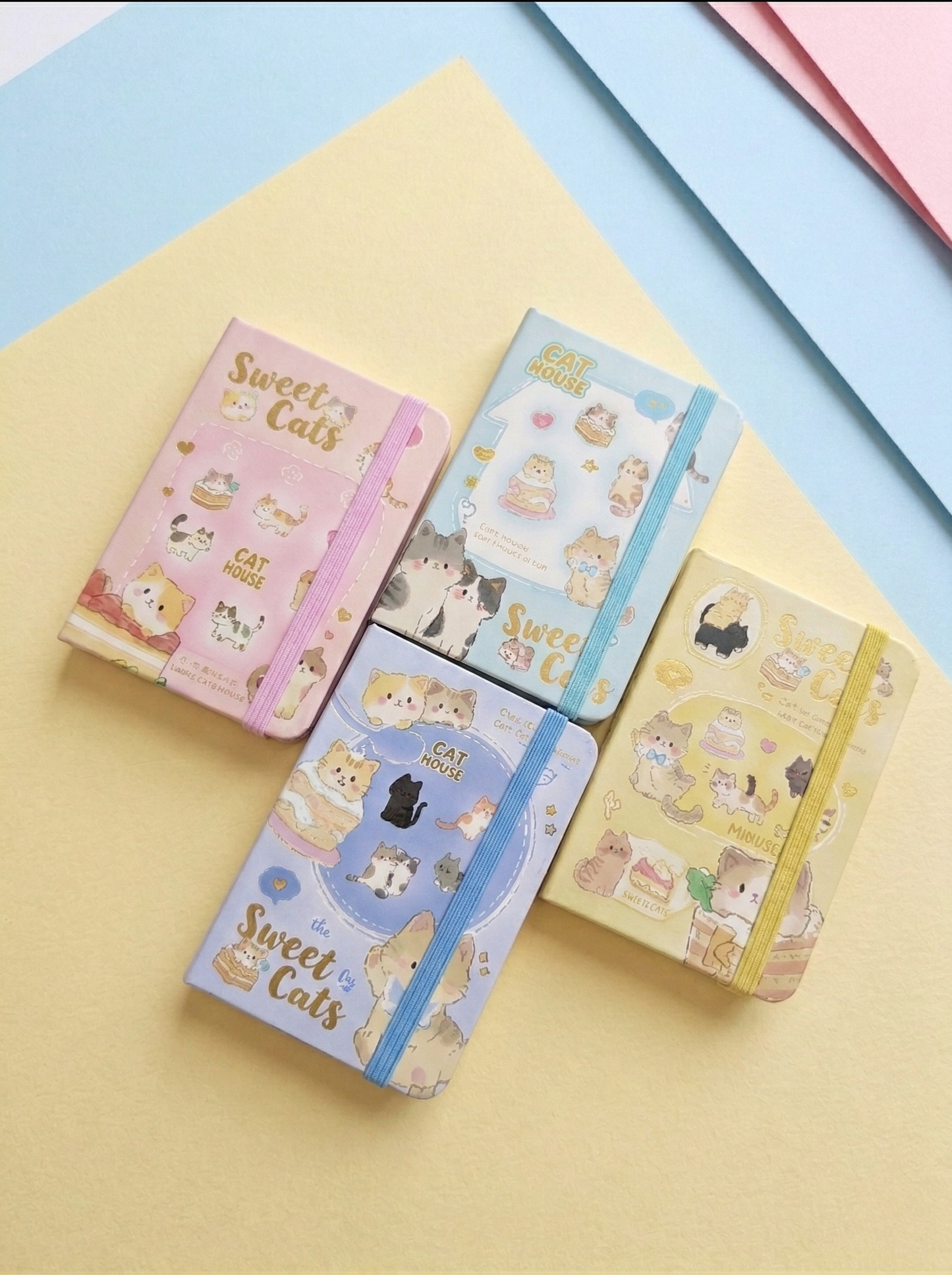 Four small notebooks with 'Sweet Cats' design on a colorful background