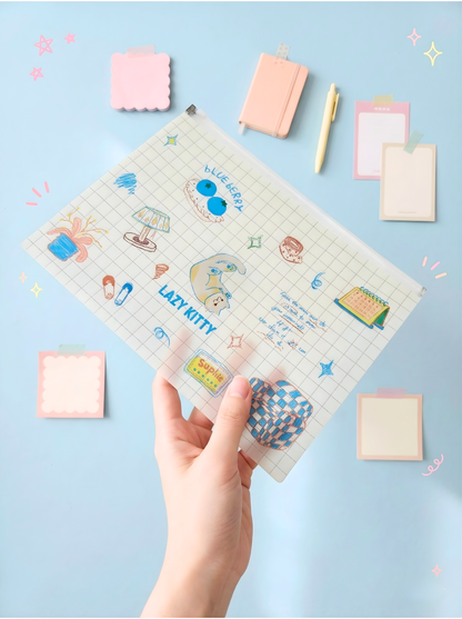 Hand holding a planner with cartoon designs on a light blue background