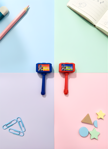 Two colorful push pins on a pastel background with stationery items.