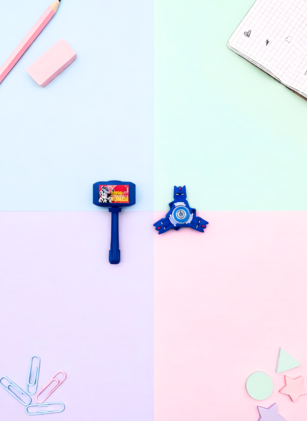 Stationery items including a blue eraser, red sharpener, and pink rubber on a light blue and pink gradient background.