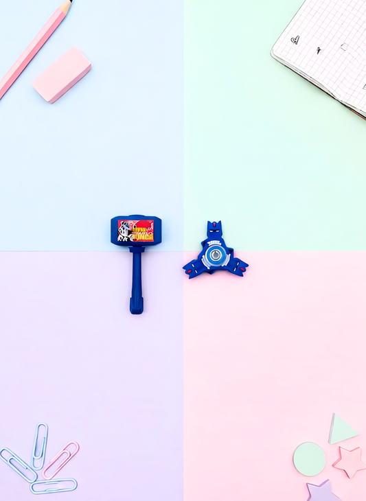 Stationery items including a blue eraser, red sharpener, and pink rubber on a light blue and pink gradient background.