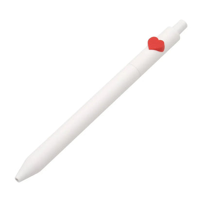White pen with a red heart-shaped clip on a white background