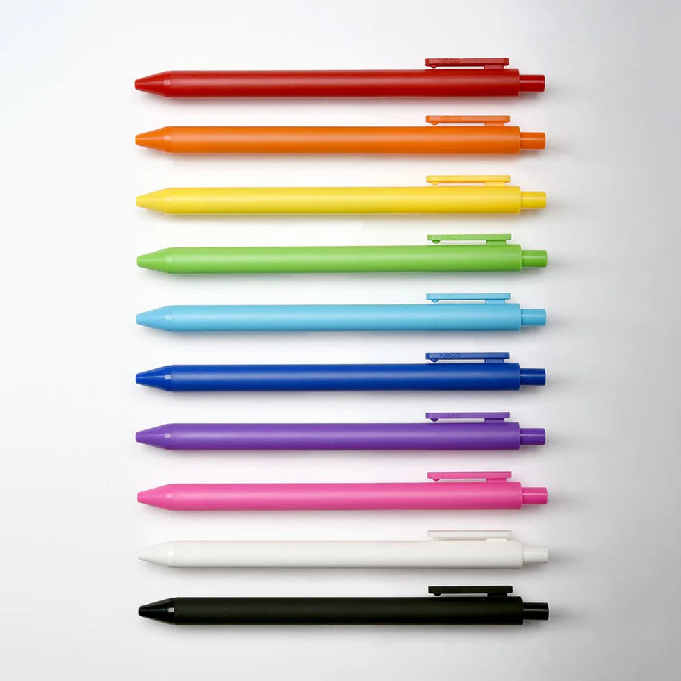 Set of colorful pens arranged in a row on a light gray background