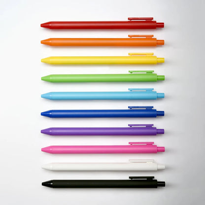 Set of colorful pens arranged in a row on a light gray background