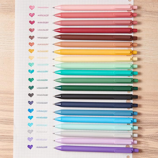 Colorful pens arranged in a gradient on a lined notebook page.
