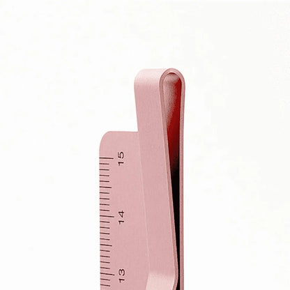 Pink hair straightener with a ruler on a white background