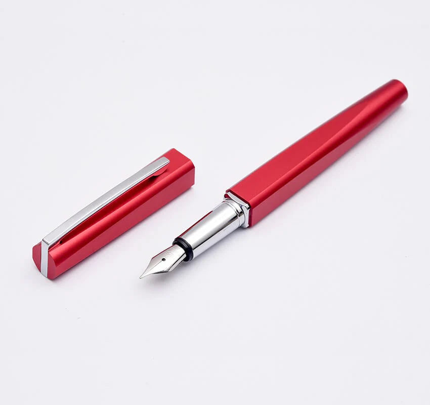 Red fountain pen with cap on a white background
