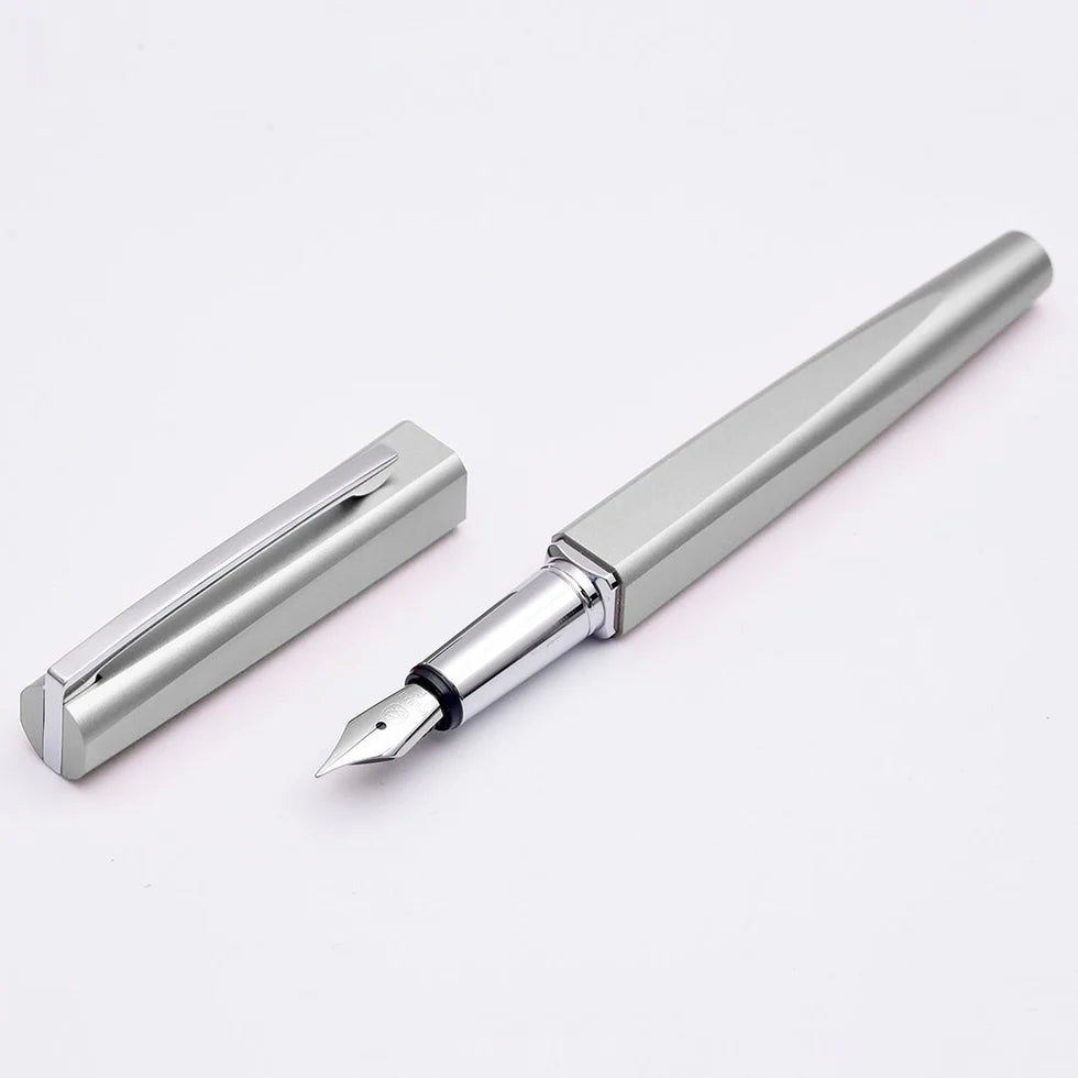 Silver fountain pen and its cap on a white background
