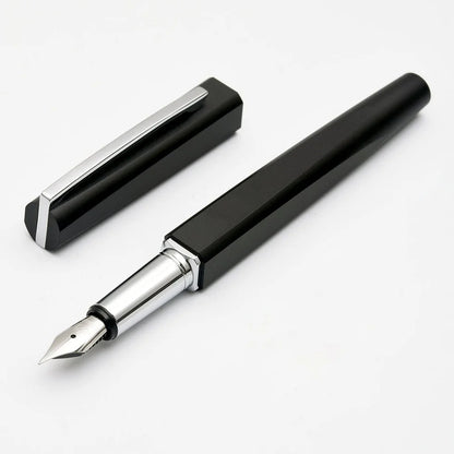 Black fountain pen with silver accents on a white background